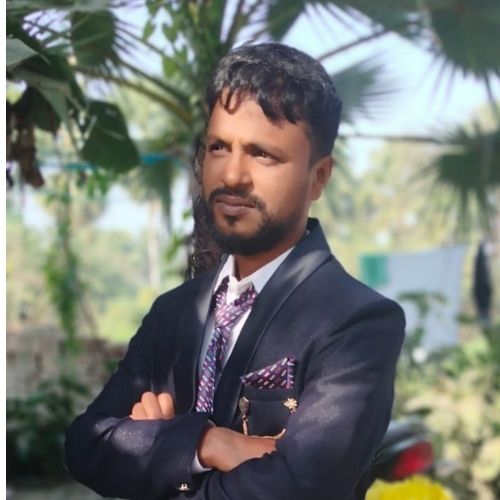 Mr. Monohar Sardar, owner of a leading shed building company in Kolkata, standing confidently outdoors in a formal suit.